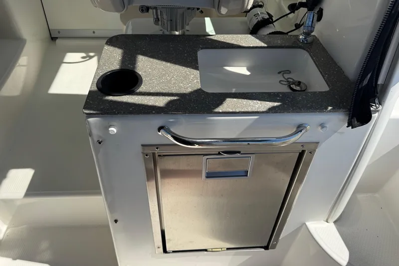  Yacht Photos Pics 2018 Boston Whaler 285 Conquest boat sink and storage area with stainless steel finish.