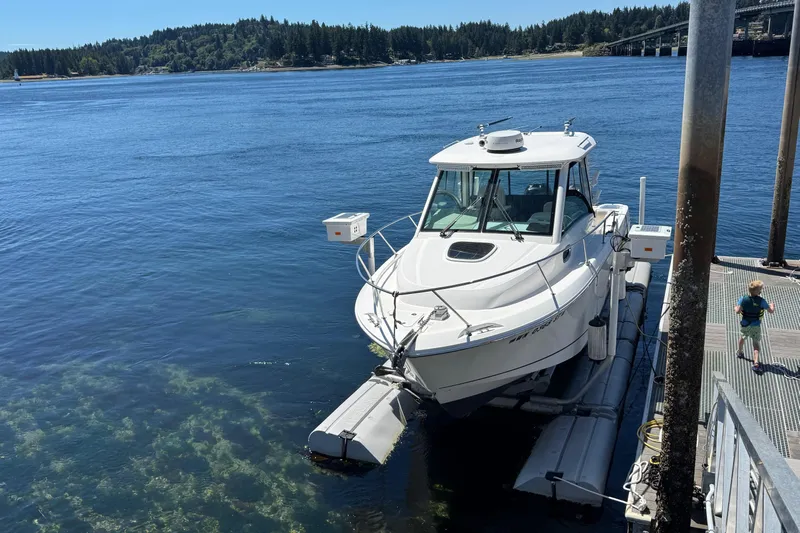  Yacht Photos Pics 2018 Boston Whaler 285 Conquest docked on a sunny day by the water.
