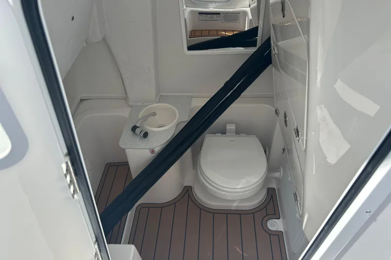  Yacht Photos Pics 2026 Sea Fox 268 Commander boat bathroom with toilet and sink, featuring wood-style flooring.