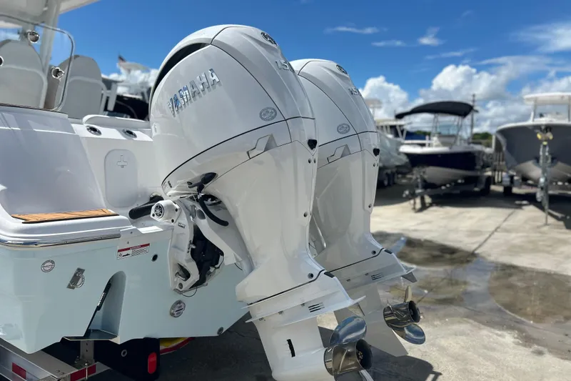  Yacht Photos Pics 2026 Sea Fox 268 Commander with dual Yamaha outboard engines, docked under a clear blue sky.