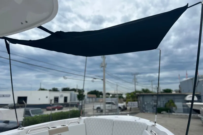  Yacht Photos Pics 2026 Sea Fox 268 Commander boat with sunshade, parked in an industrial area.