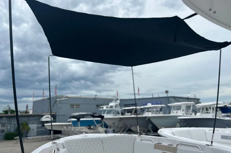  Yacht Photos Pics 2026 Sea Fox 268 Commander boat with canopy, docked under cloudy sky.