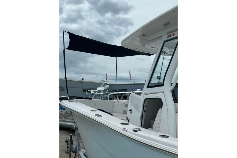  Yacht Photos Pics 2026 Sea Fox 268 Commander boat with canopy, docked under cloudy skies.