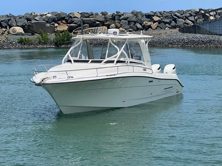  Yacht Photos Pics 2008 Hydra-Sports 3500VX boat on calm water near rocky shore.