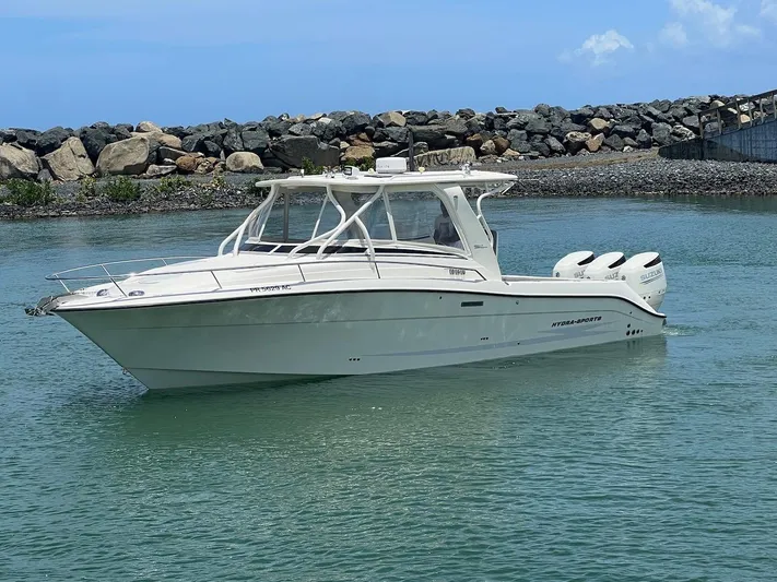  Yacht Photos Pics 2008 Hydra-Sports 3500VX boat cruising in calm waters near rocky shoreline.