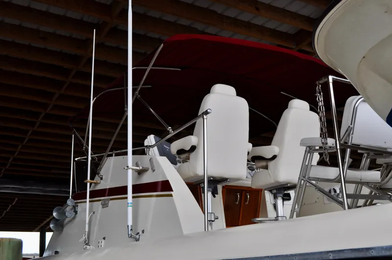 Mad Hatteras Yacht Photos Pics 1981 Hatteras 53 Motor Yacht with white seating under a red canopy in a covered dock.