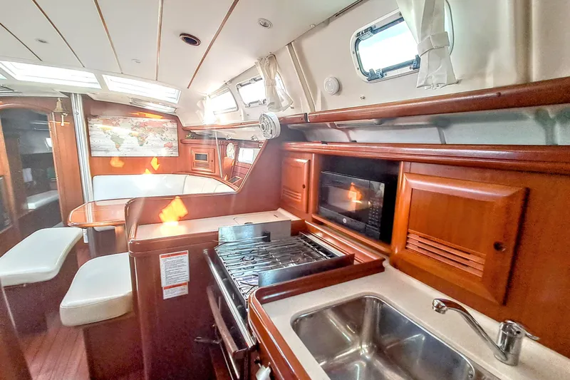 Anyroad Yacht Photos Pics Interior of 2006 Beneteau 423 yacht with kitchen, seating, and map decor.