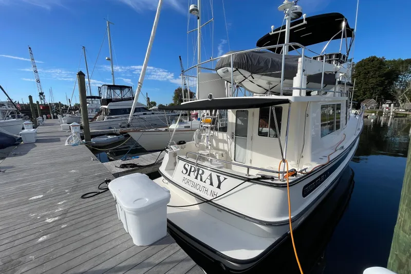 Spray Yacht Photos Pics 2015 Nordic Tug 39 Flybridge docked at marina under clear blue sky.