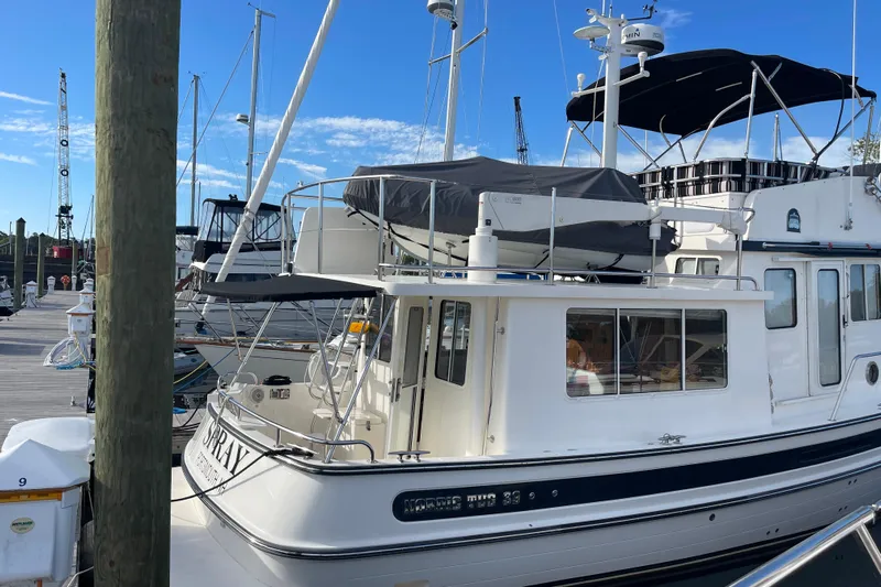 Spray Yacht Photos Pics 2015 Nordic Tug 39 Flybridge docked at marina under clear blue sky.