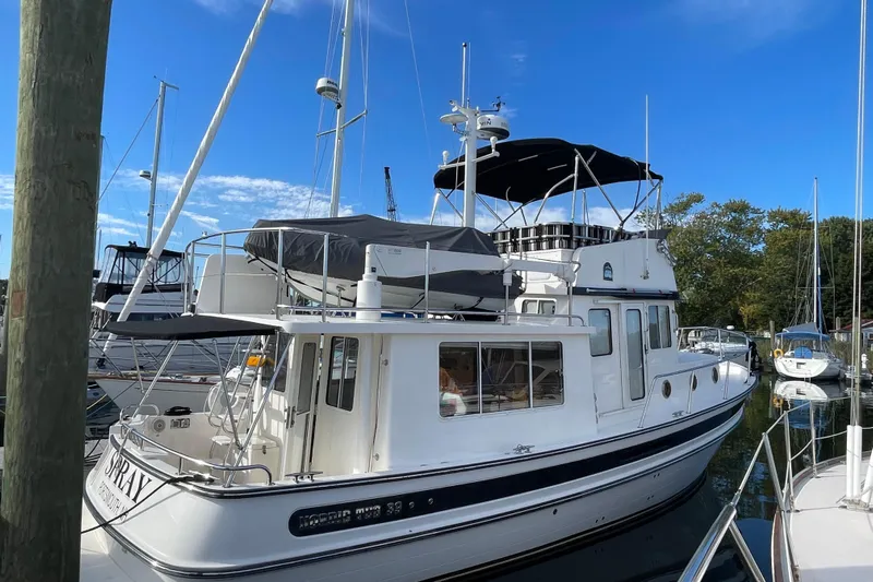 Spray Yacht Photos Pics 2015 Nordic Tug 39 Flybridge docked in a marina under a clear blue sky.