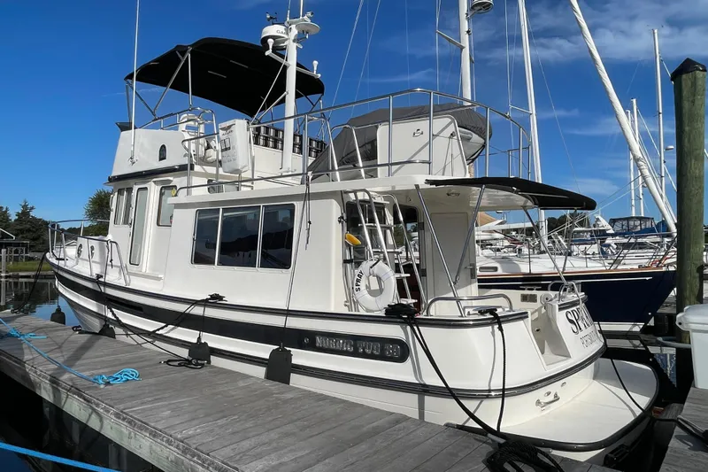 Spray Yacht Photos Pics 2015 Nordic Tug 39 Flybridge docked at marina under clear blue sky.