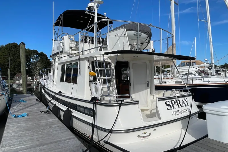 Spray Yacht Photos Pics 2015 Nordic Tug 39 Flybridge docked at marina, rear view.