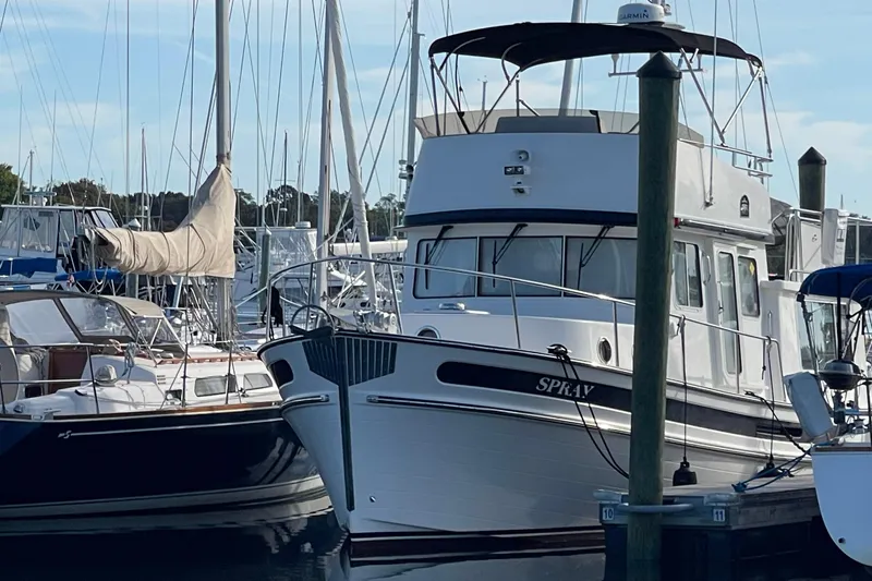 Spray Yacht Photos Pics 2015 Nordic Tug 39 Flybridge docked at marina, surrounded by sailboats.