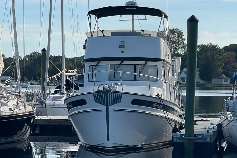 Spray Yacht Photos Pics 2015 Nordic Tug 39 Flybridge docked at a marina, surrounded by sailboats.