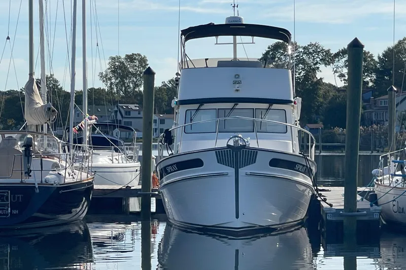 Spray Yacht Photos Pics 2015 Nordic Tug 39 Flybridge docked at a marina, surrounded by sailboats.