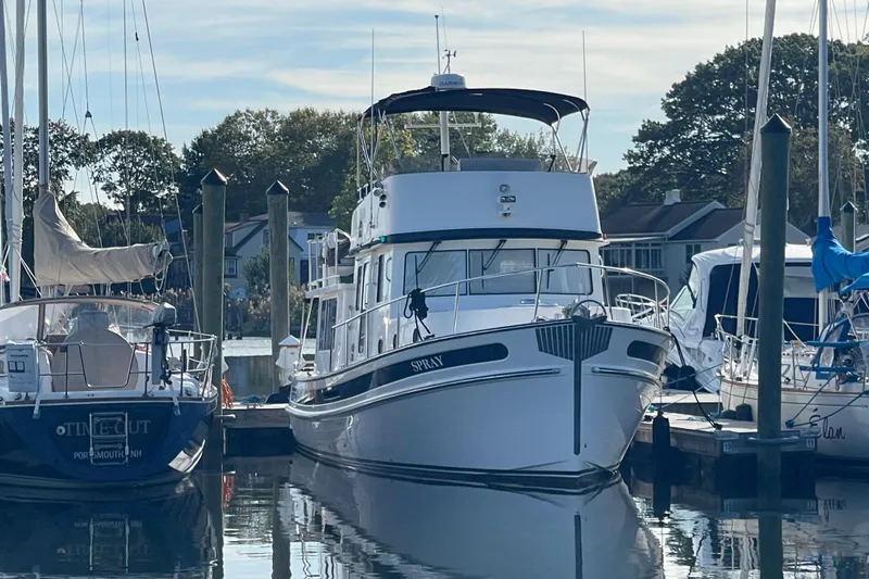 Spray Yacht Photos Pics 2015 Nordic Tug 39 Flybridge docked at a marina, surrounded by sailboats.