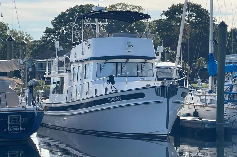 Spray Yacht Photos Pics 2015 Nordic Tug 39 Flybridge docked at a marina, surrounded by other boats.