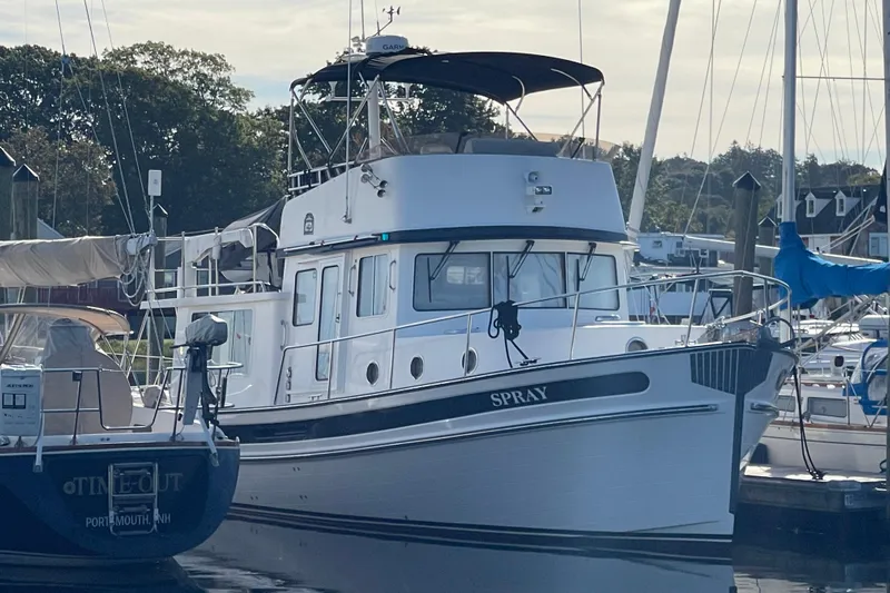 Spray Yacht Photos Pics 2015 Nordic Tug 39 Flybridge docked at marina, surrounded by other boats.