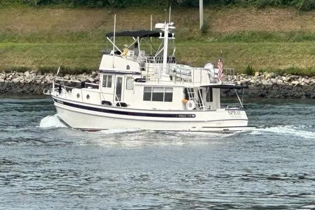 Spray Yacht Photos Pics 2015 Nordic Tug 39 Flybridge cruising on a calm waterway.