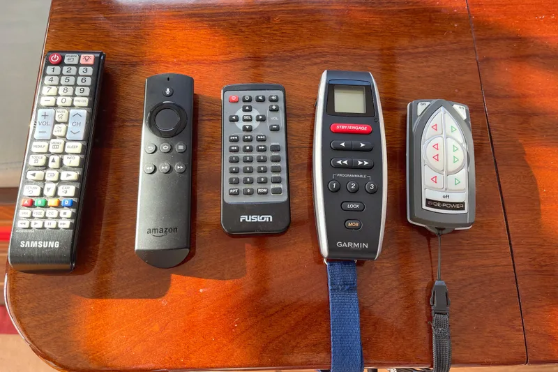Spray Yacht Photos Pics Five remote controls on a wooden surface, including Samsung, Amazon, Fusion, Garmin, and Side-Power. Nordic Tug 39, 2015.