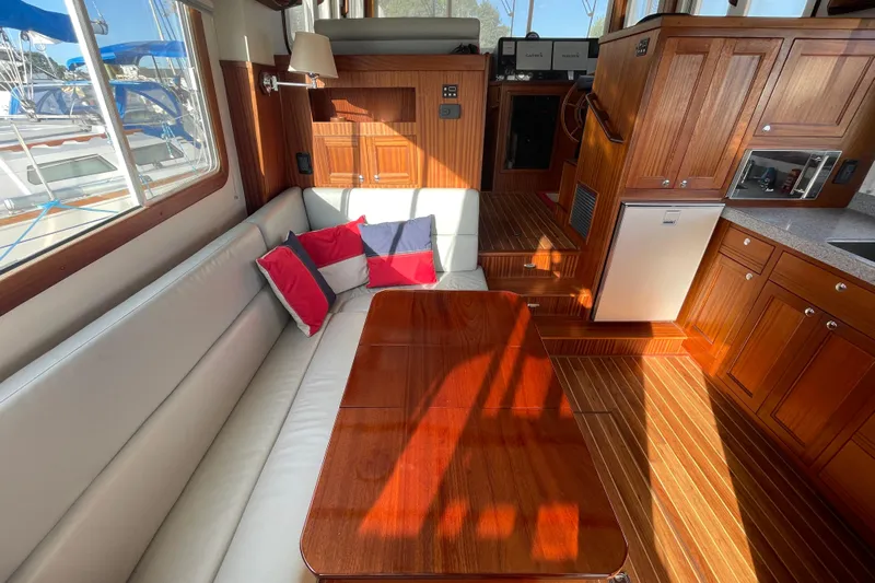 Spray Yacht Photos Pics Luxurious interior of 2015 Nordic Tug 39 with wood finish and cozy seating area.