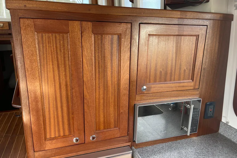 Spray Yacht Photos Pics Wooden cabinetry and microwave in 2015 Nordic Tug 39 boat interior.