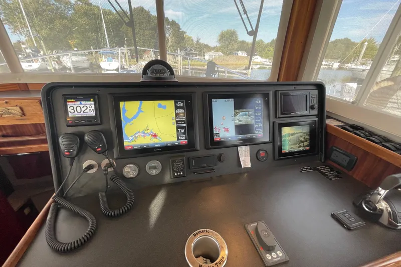 Spray Yacht Photos Pics Control panel of a 2015 Nordic Tug 39 with navigation screens and communication devices.