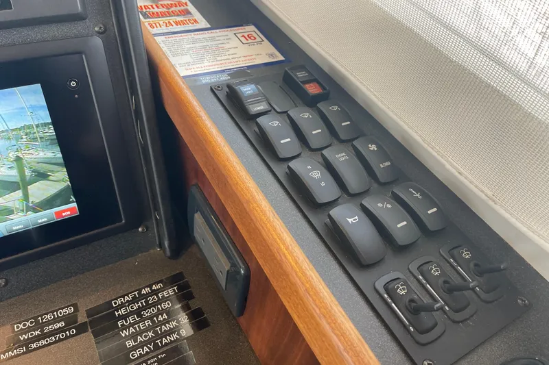 Spray Yacht Photos Pics Control panel of a 2015 Nordic Tug 39 with switches and display screen.