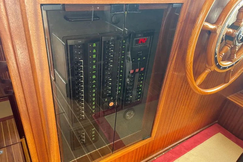 Spray Yacht Photos Pics Electrical panel and wooden steering wheel on a 2015 Nordic Tug 39 boat.