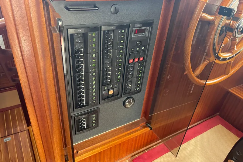 Spray Yacht Photos Pics Electrical panel and wooden steering wheel on a 2015 Nordic Tug 39 boat.