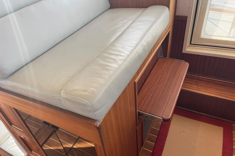 Spray Yacht Photos Pics Interior of 2015 Nordic Tug 39 with cushioned seating and wooden accents.