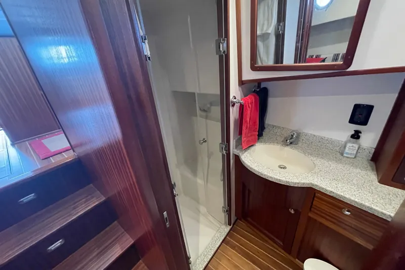 Spray Yacht Photos Pics 2015 Nordic Tug 39 bathroom with wood cabinetry, granite countertop, and shower.