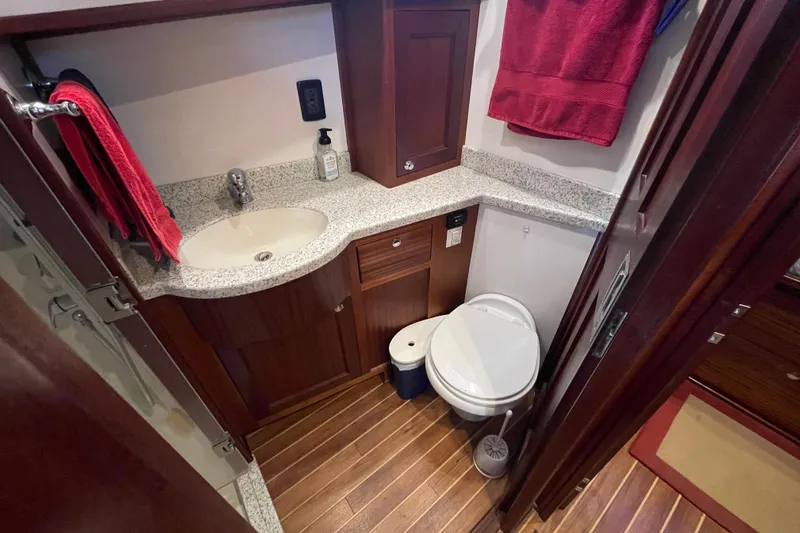 Spray Yacht Photos Pics Bathroom interior of 2015 Nordic Tug 39 with wood accents and granite countertop.