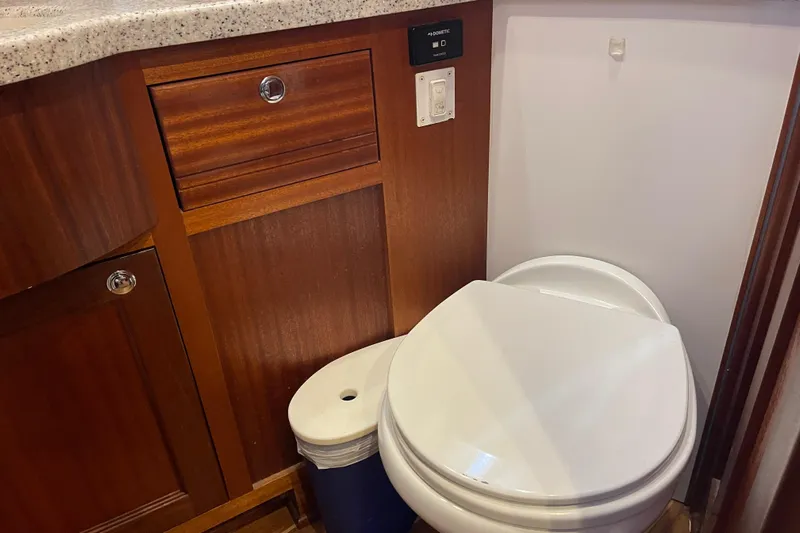 Spray Yacht Photos Pics Bathroom interior of 2015 Nordic Tug 39 with wooden cabinetry and modern toilet.