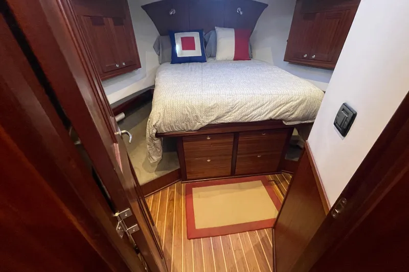 Spray Yacht Photos Pics Cozy bedroom in 2015 Nordic Tug 39 with wooden cabinetry and comfortable bedding.