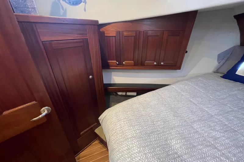 Spray Yacht Photos Pics Cozy cabin interior of 2015 Nordic Tug 39 with wooden cabinetry and bed.