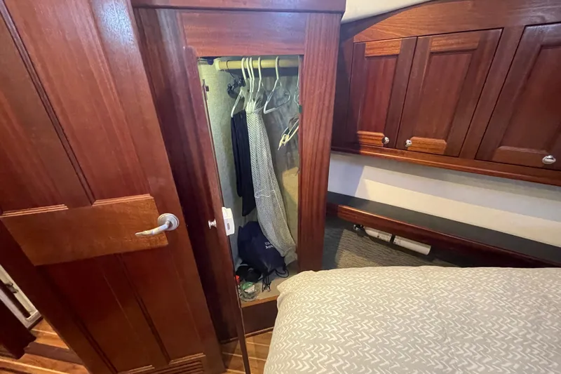 Spray Yacht Photos Pics Wooden closet interior on a 2015 Nordic Tug 39 boat, featuring hangers and storage space.