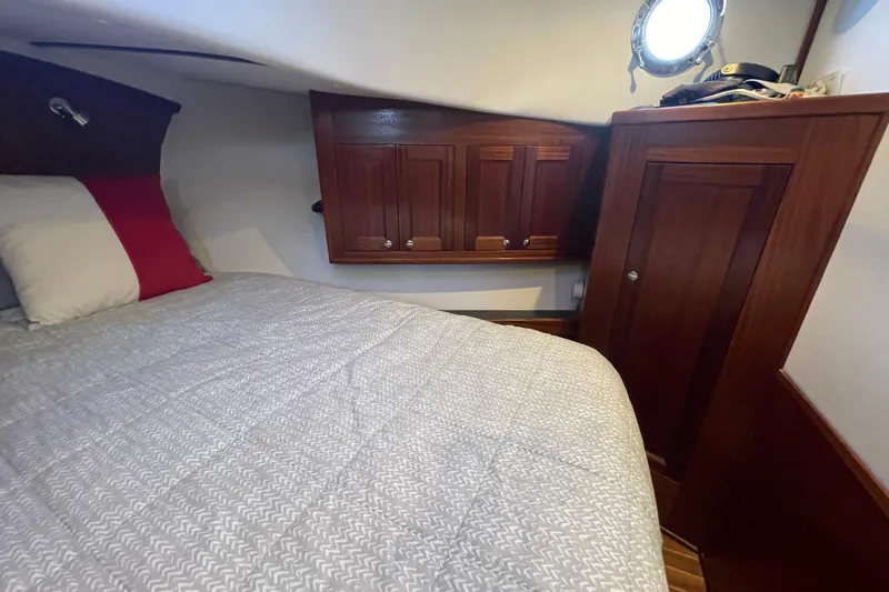 Spray Yacht Photos Pics Cozy cabin interior of 2015 Nordic Tug 39 with wooden cabinetry and porthole.