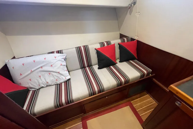 Spray Yacht Photos Pics Cozy seating area in 2015 Nordic Tug 39 with striped cushions and decorative pillows.