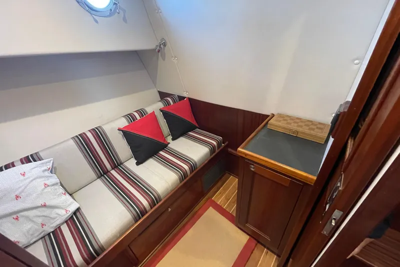 Spray Yacht Photos Pics Cozy interior of 2015 Nordic Tug 39 with striped seating and wooden cabinetry.