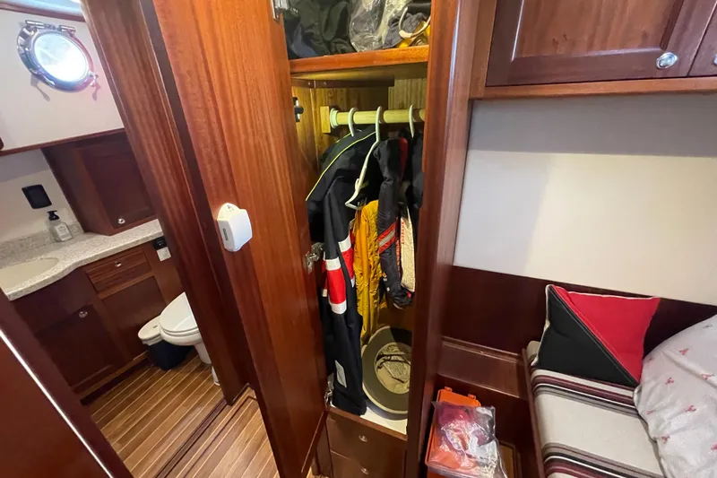 Spray Yacht Photos Pics Cozy interior of 2015 Nordic Tug 39 with closet, bed, and bathroom.
