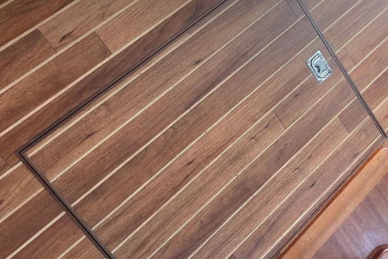Spray Yacht Photos Pics Teak wood flooring on 2015 Nordic Tug 39 boat, featuring a metal latch.