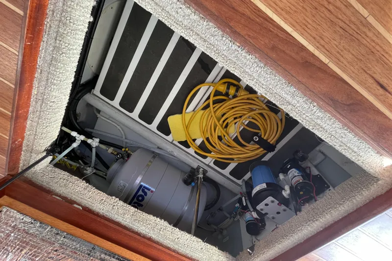Spray Yacht Photos Pics Engine compartment of a 2015 Nordic Tug 39 with equipment and coiled yellow hose.