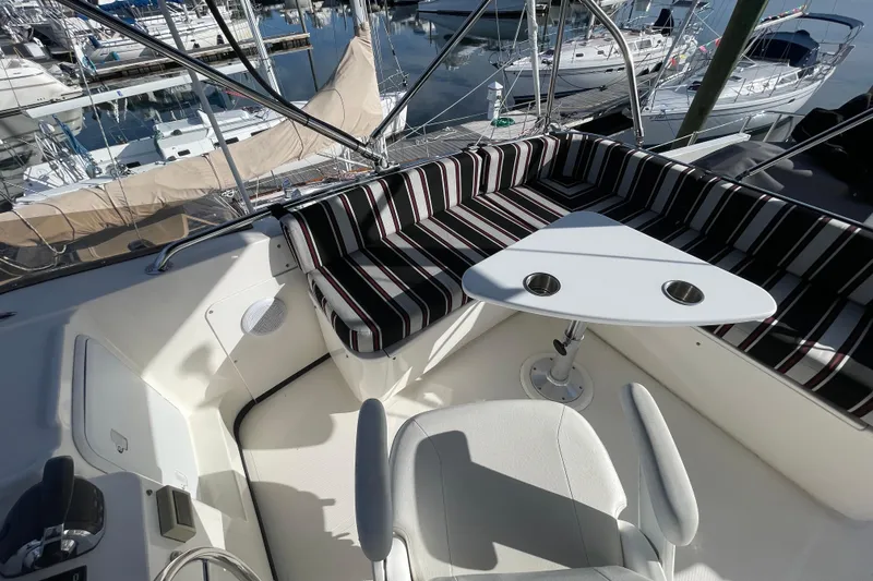 Spray Yacht Photos Pics 2015 Nordic Tug 39 interior with striped seating and triangular table in marina setting.