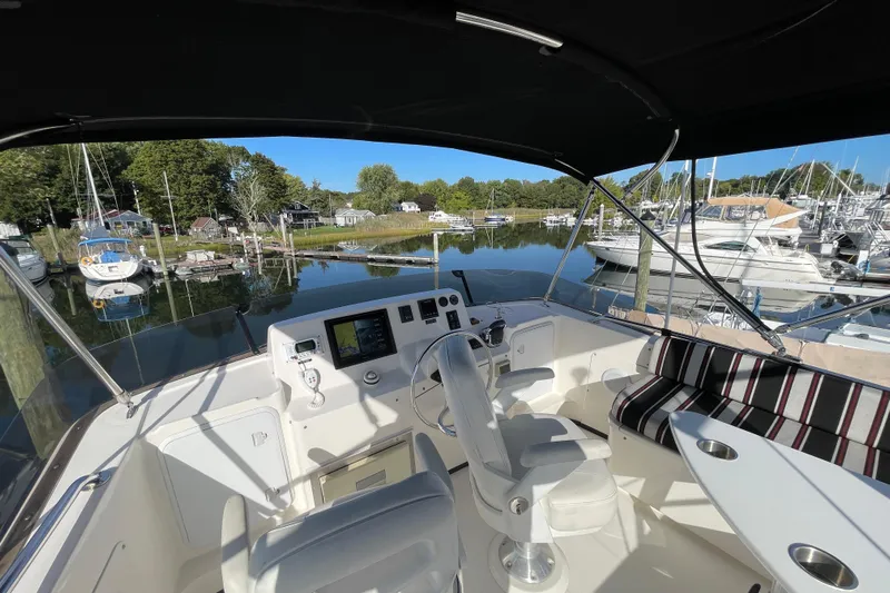 Spray Yacht Photos Pics 2015 Nordic Tug 39 cockpit with helm, seating, and marina view.
