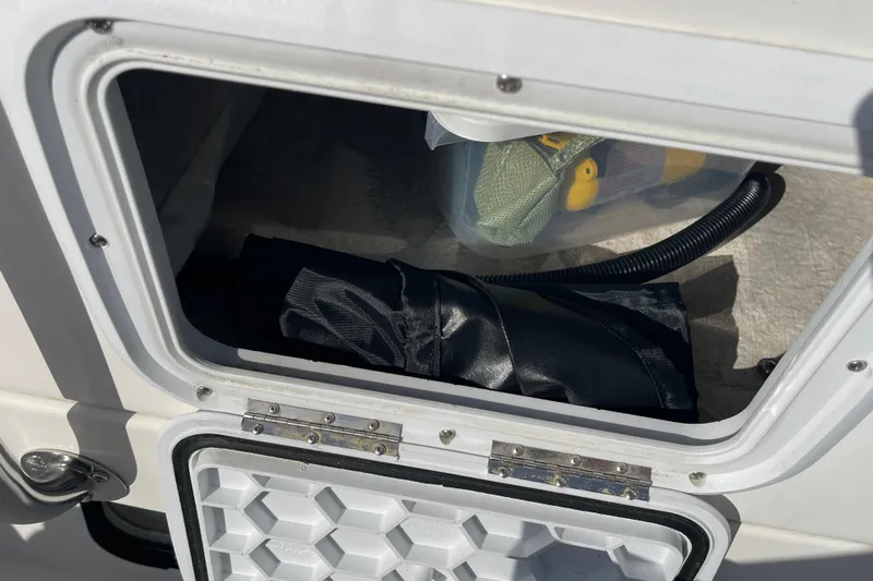 Spray Yacht Photos Pics Storage compartment on a 2015 Nordic Tug 39 boat, containing equipment and accessories.