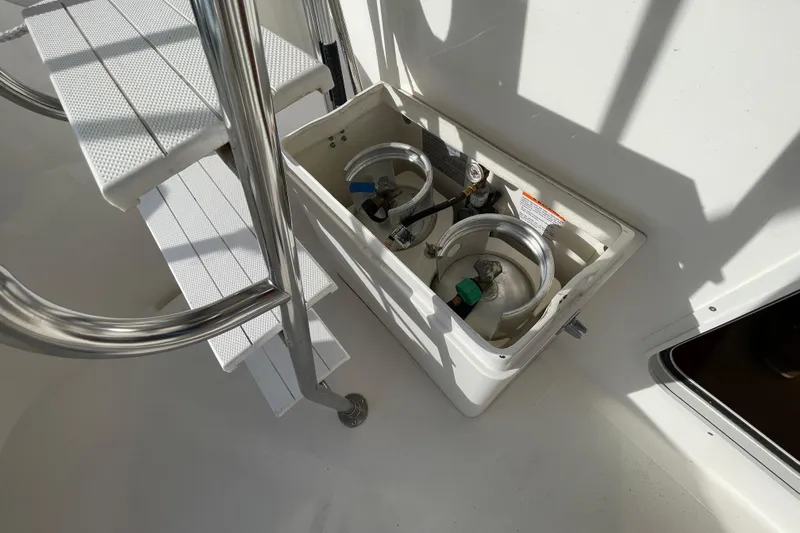 Spray Yacht Photos Pics Nordic Tug 39 (2015) boat deck with propane storage compartment and metal ladder.