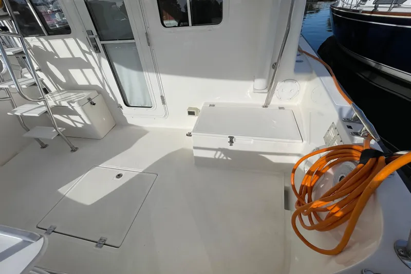 Spray Yacht Photos Pics 2015 Nordic Tug 39 boat deck with storage, ladder, and coiled orange hose.