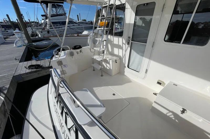 Spray Yacht Photos Pics 2015 Nordic Tug 39 docked, featuring spacious deck and ladder access.