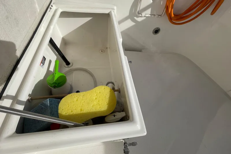 Spray Yacht Photos Pics Storage compartment on 2015 Nordic Tug 39 with cleaning supplies and hose.
